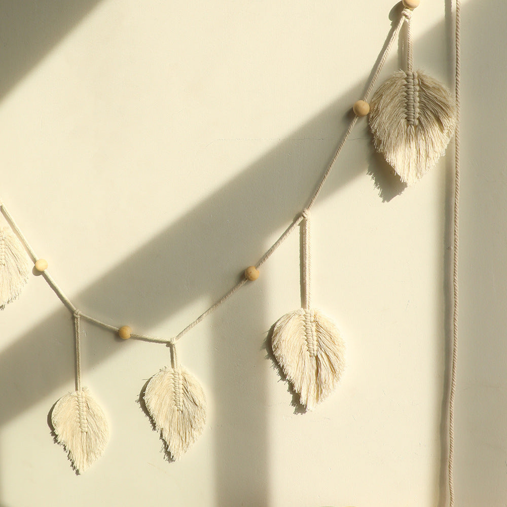Decorative feather garland on a plain wall