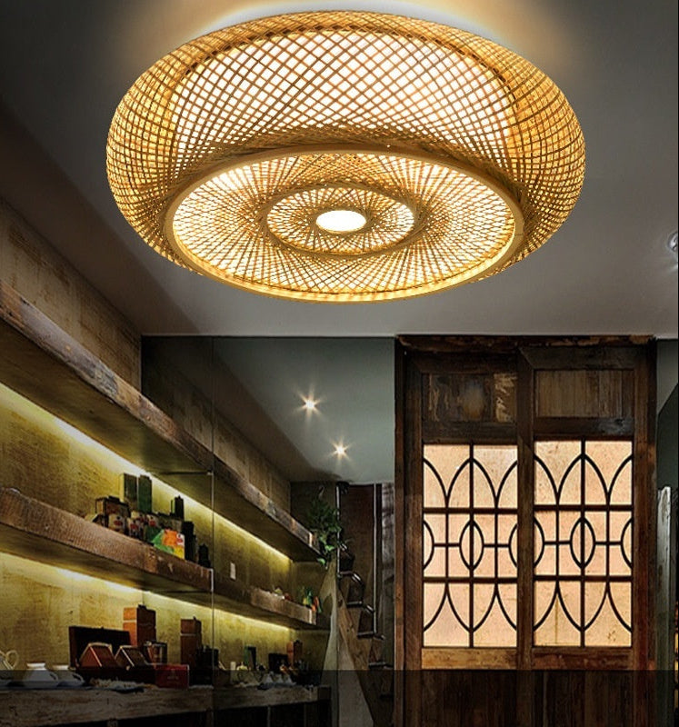 Woven ceiling light fixture in a room with wooden shelves and decorative elements.