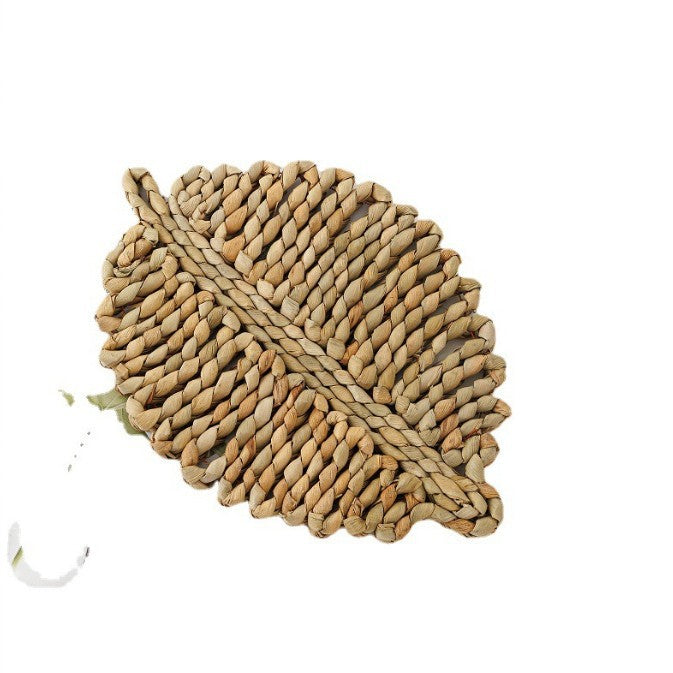 Woven leaf-shaped mat on a white background