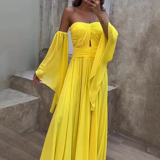 Yellow strapless dress with flowing sleeves worn by a person, standing on a wooden floor.
