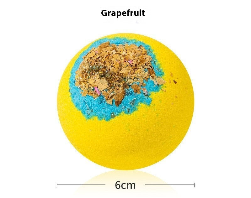 Yellow bath bomb with grapefruit flavor and visible texture on a white background