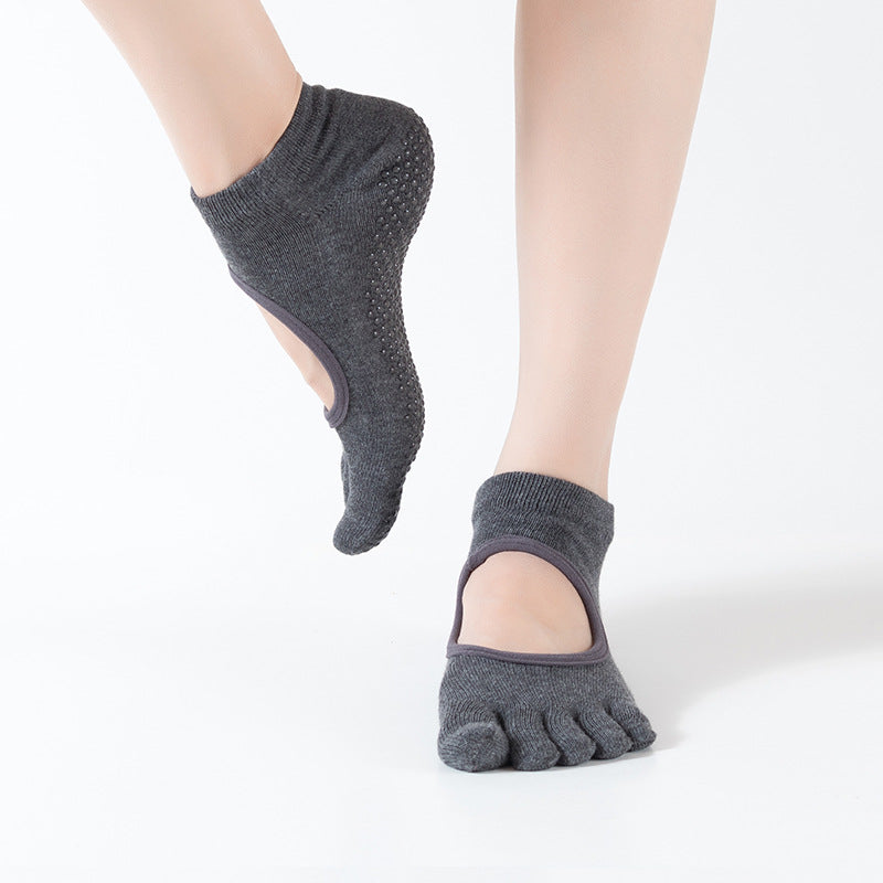 Gray five-finger socks worn on a white background