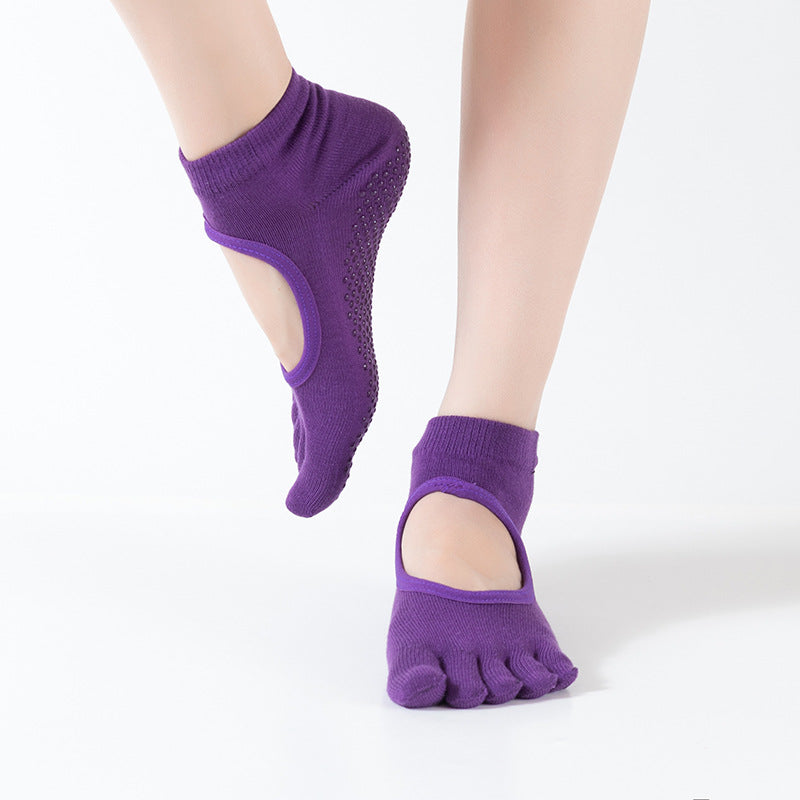 Purple yoga socks with toe separation on a white background