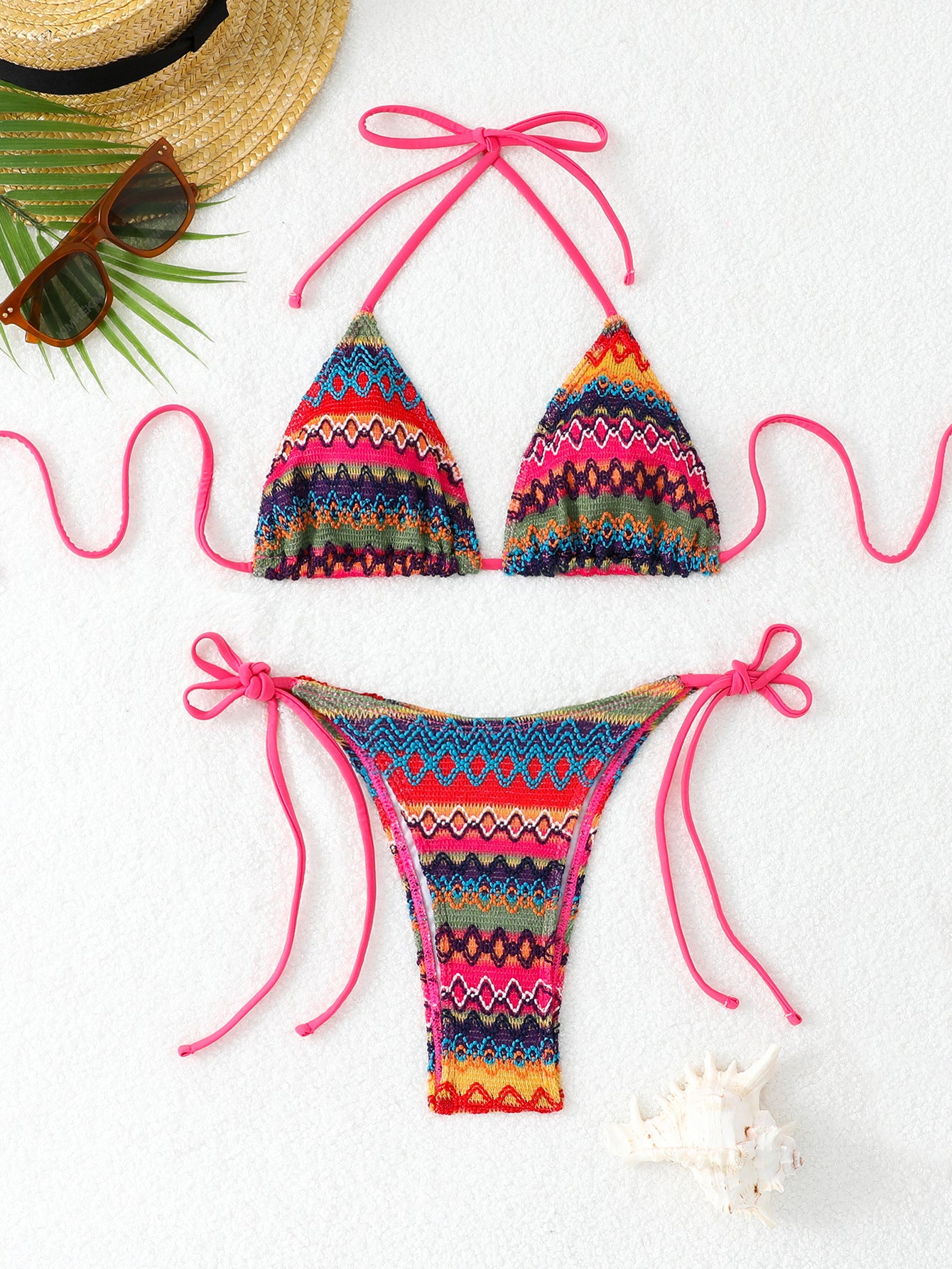 Colorful bikini set with pink strings on a white background