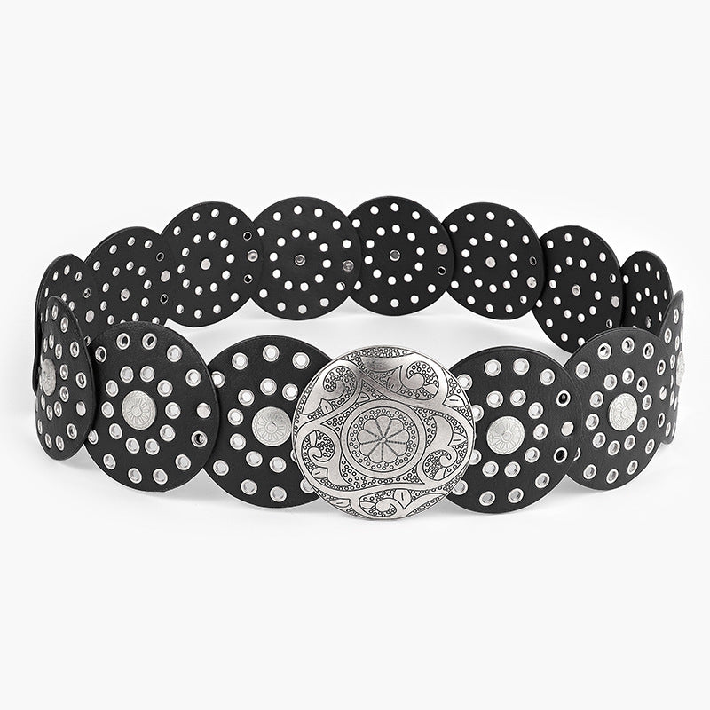 Black and silver belt with decorative buckle on a white background