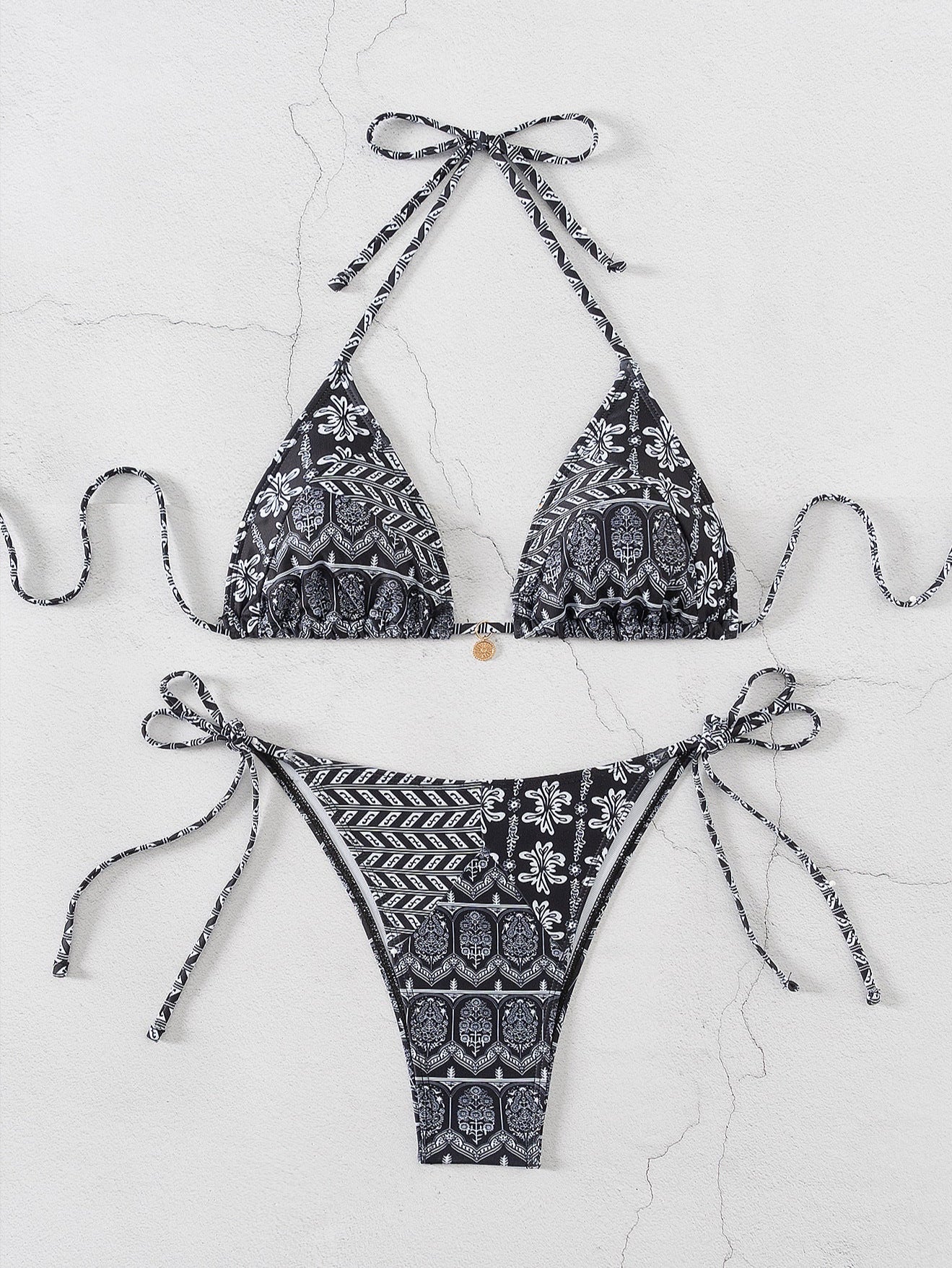 Black and white patterned bikini set on a light gray background