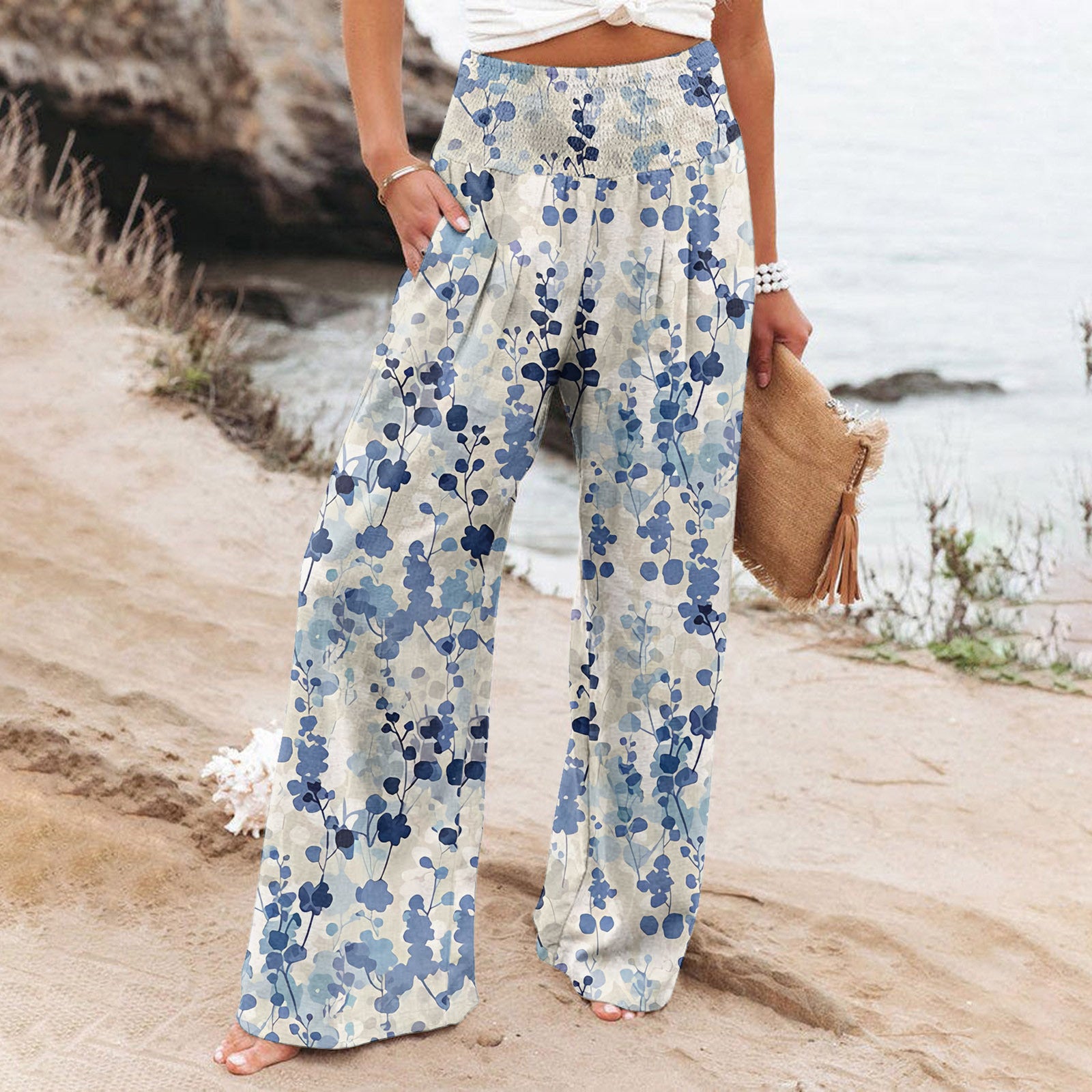 Person wearing floral pants on a beach