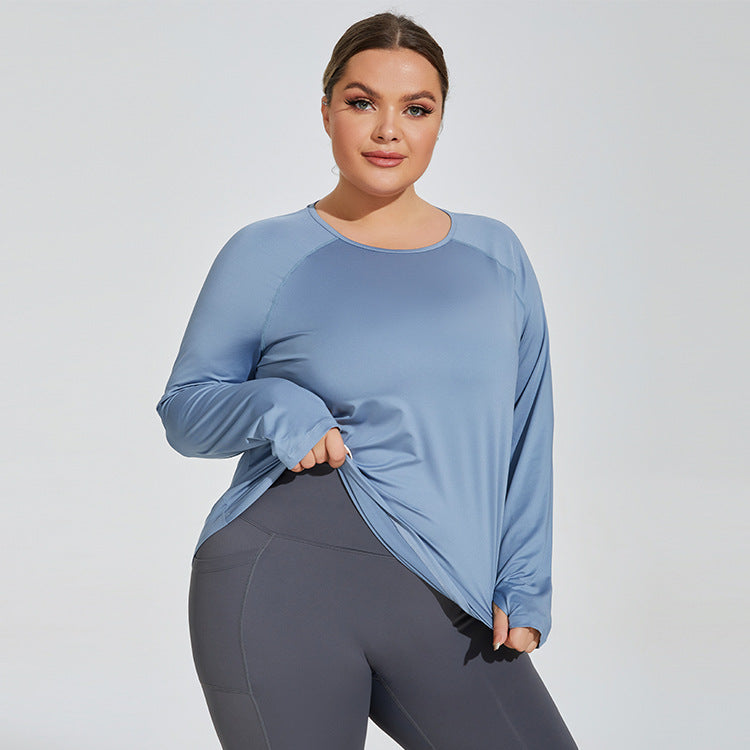 Woman wearing a blue long-sleeve top and gray leggings on a light gray background