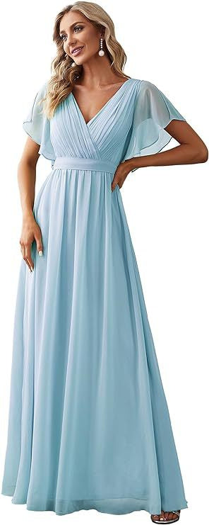 Woman wearing a light blue dress with a V-neck and short sleeves.