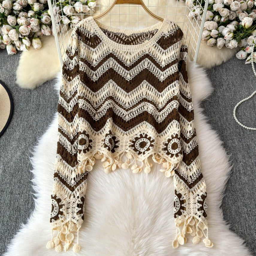 Crocheted sweater with zigzag pattern on a hanger against a floral and fur background