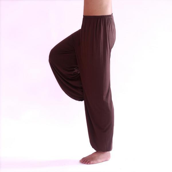 Brown baggy pants worn by a person on a white background