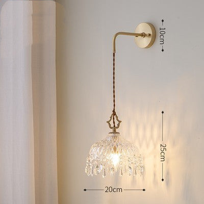 Wall-mounted lamp with crystal shade and gold arm, dimensions indicated.