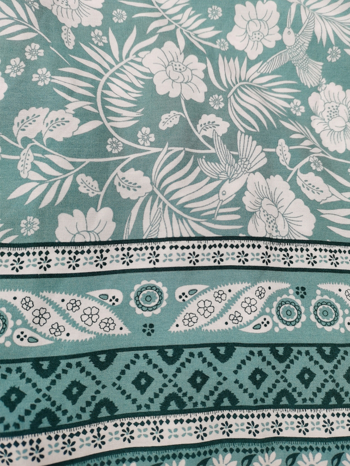 Teal fabric with white floral and bird pattern