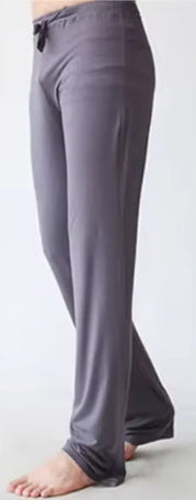 Gray pants worn by a person on a white background