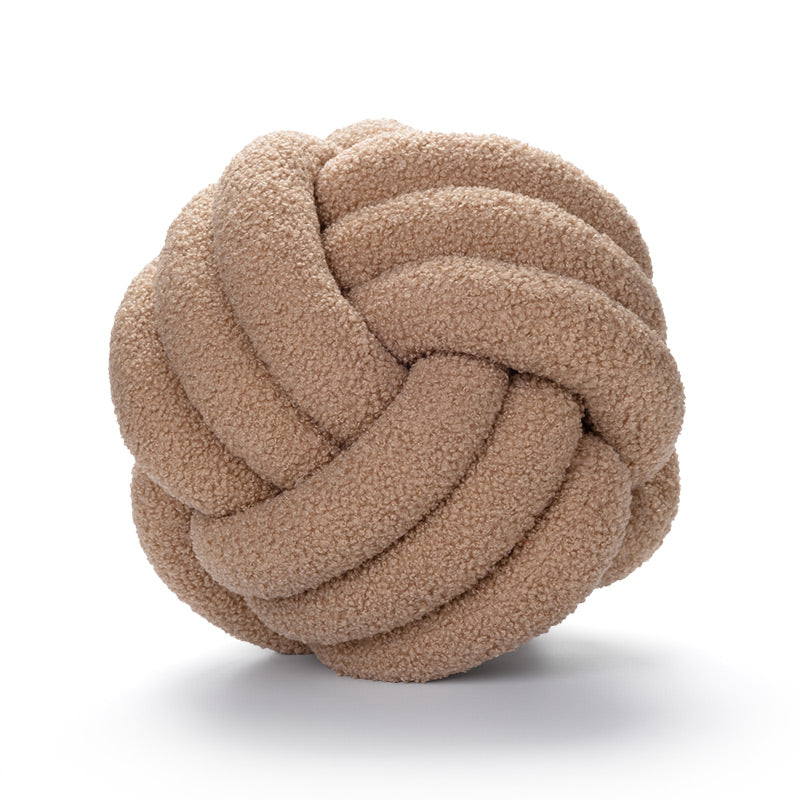 khaki knotted fabric ball on a white background
