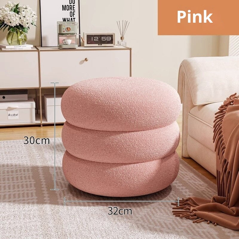 Pink textured ottoman in a living room setting with measurements indicated.