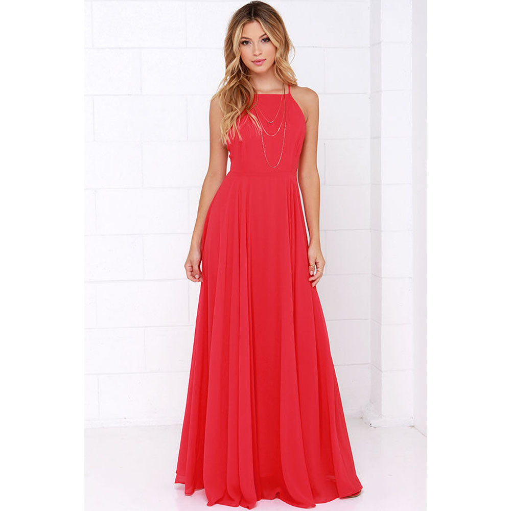 Woman wearing a red halter neck dress against a white background