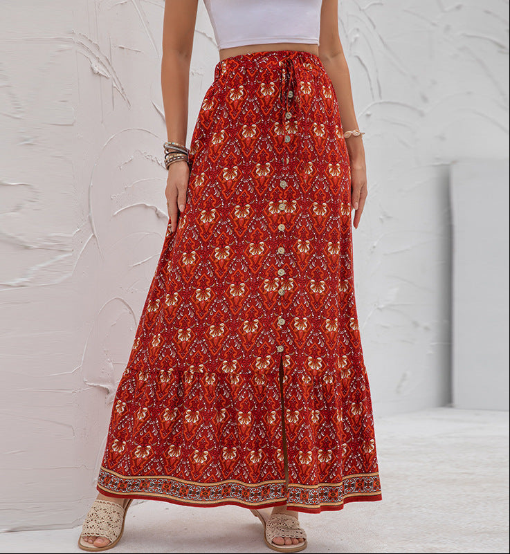 Red patterned skirt worn by a person on a light gray background