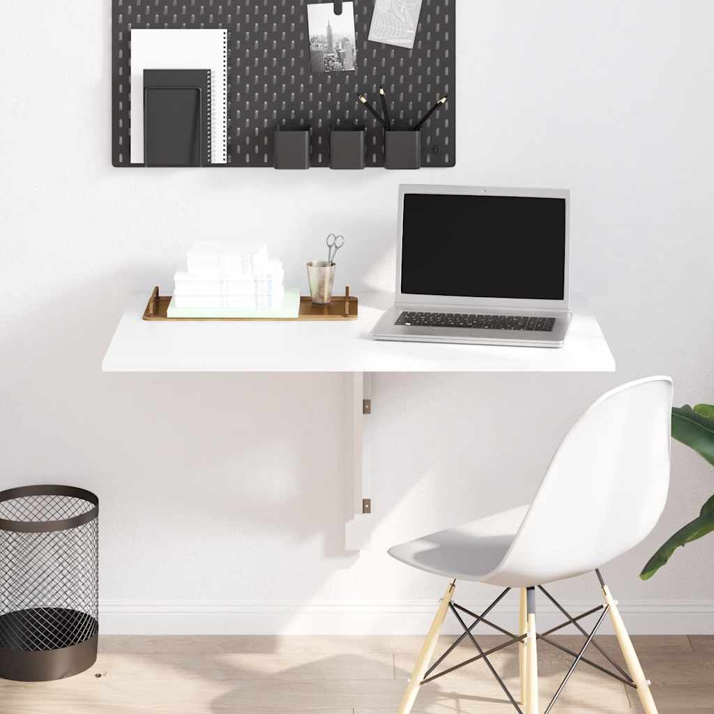 Modern home office with a white desk, laptop, chair, and decorative items.
