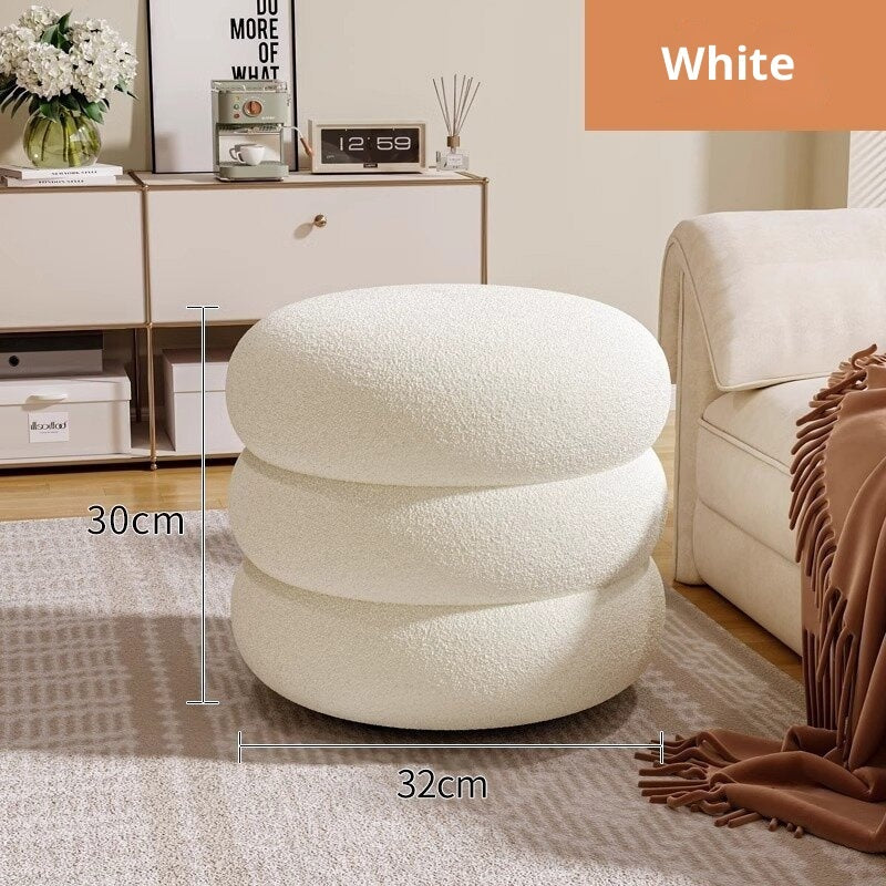 White textured ottoman with dimensions in a living room setting