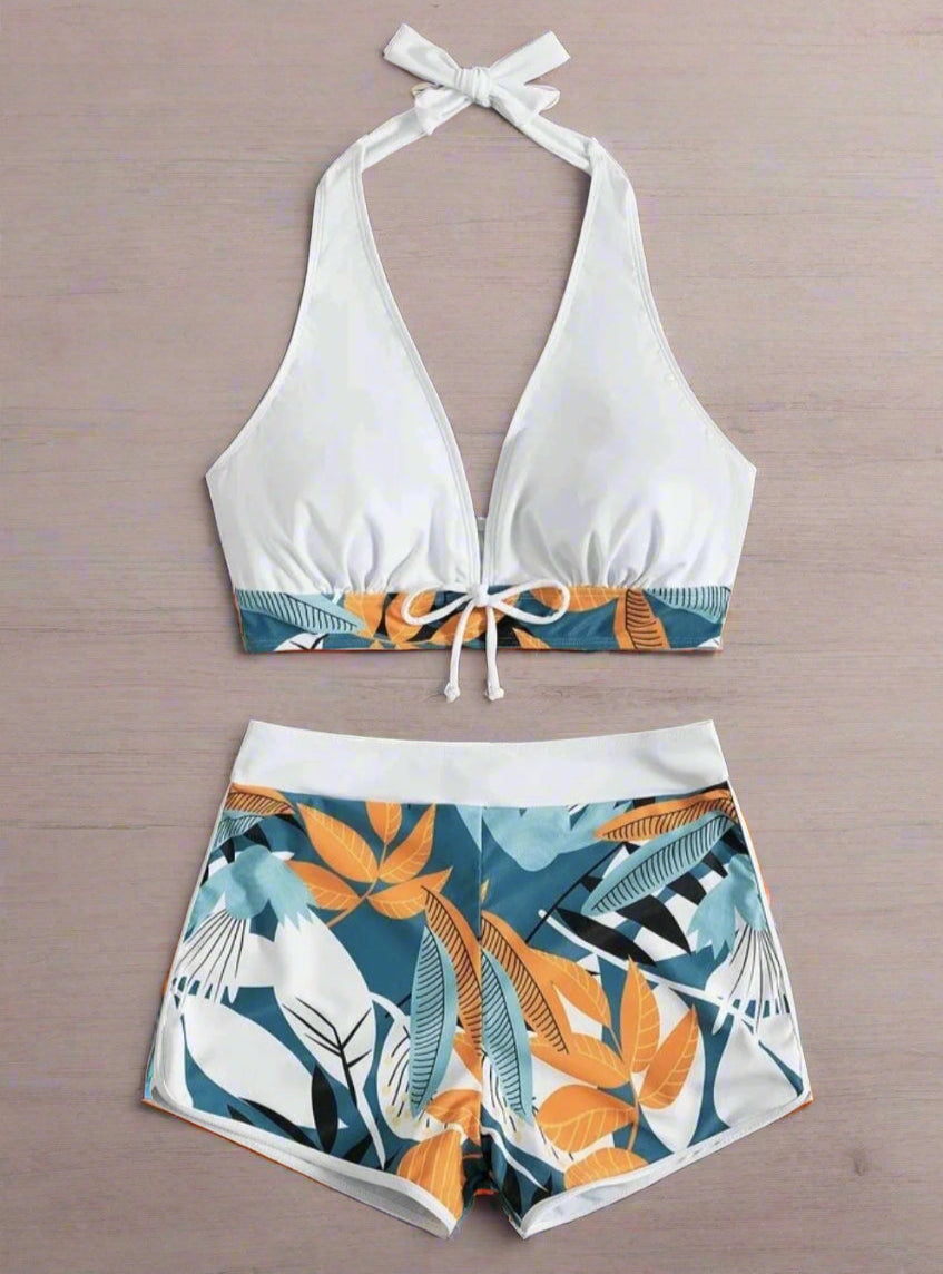 Two-piece swimsuit with top and shorts on a wooden surface