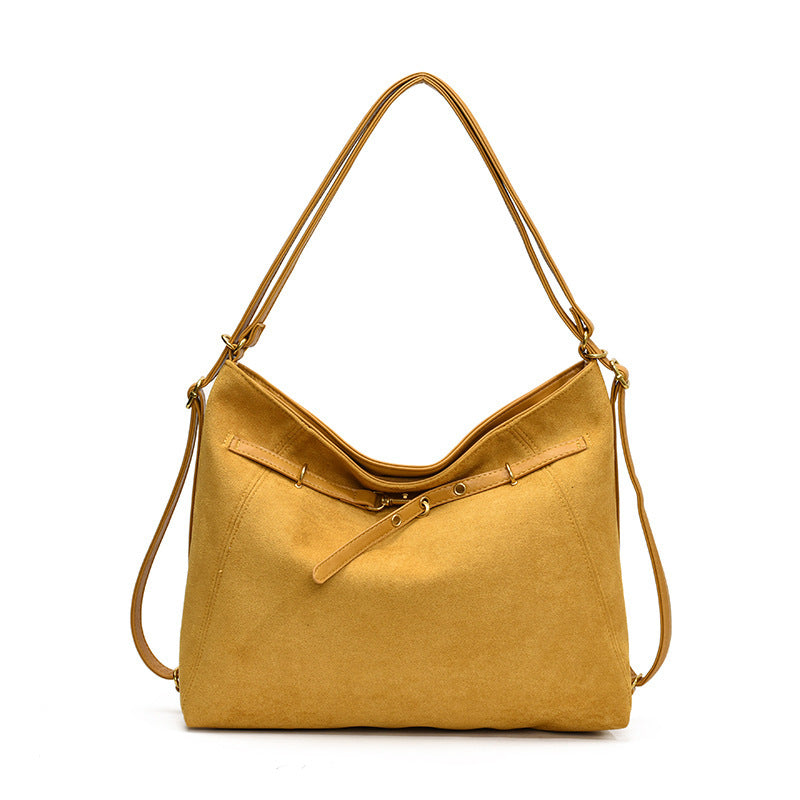 Yellow handbag with a shoulder strap on a white background